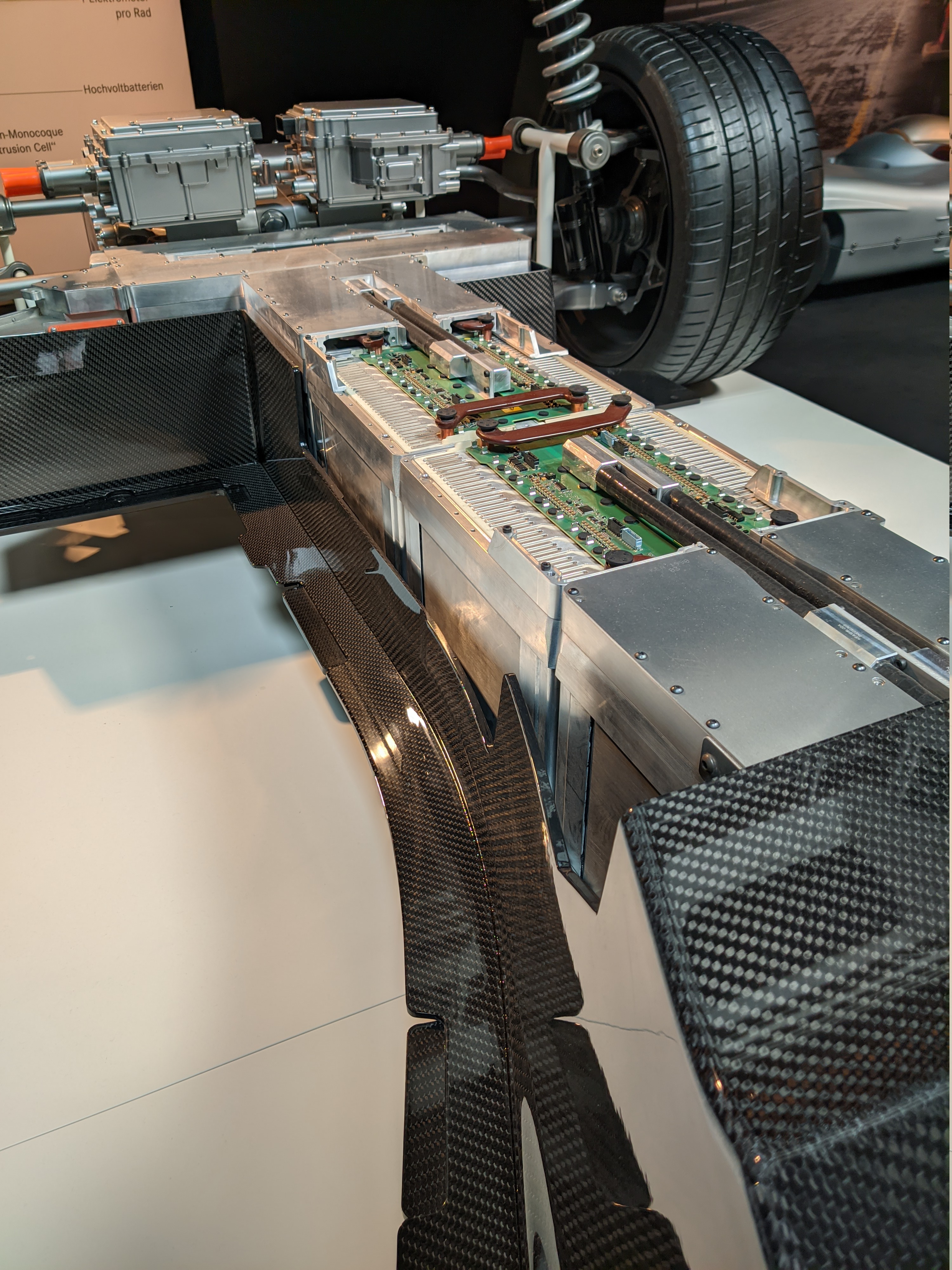 An exposed electric vehicle battery and chassis on display.