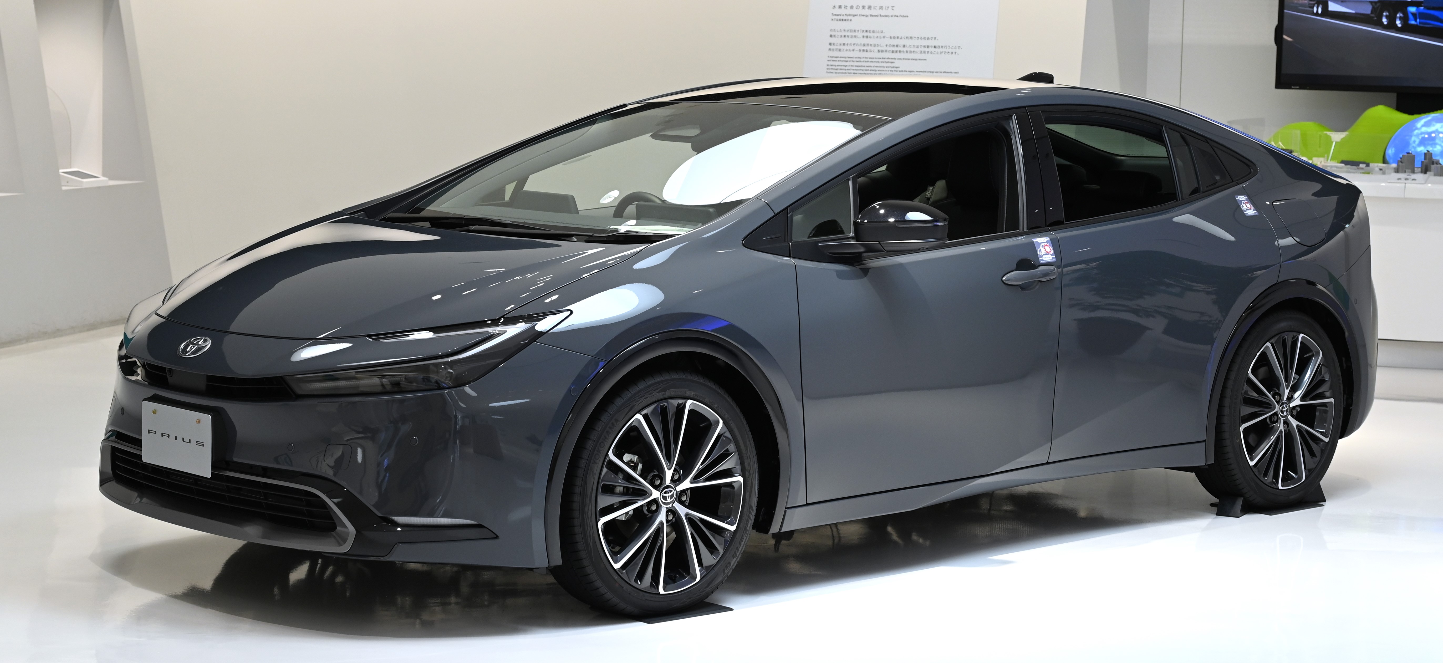 A gray 2023 Toyota Prius on display indoors.