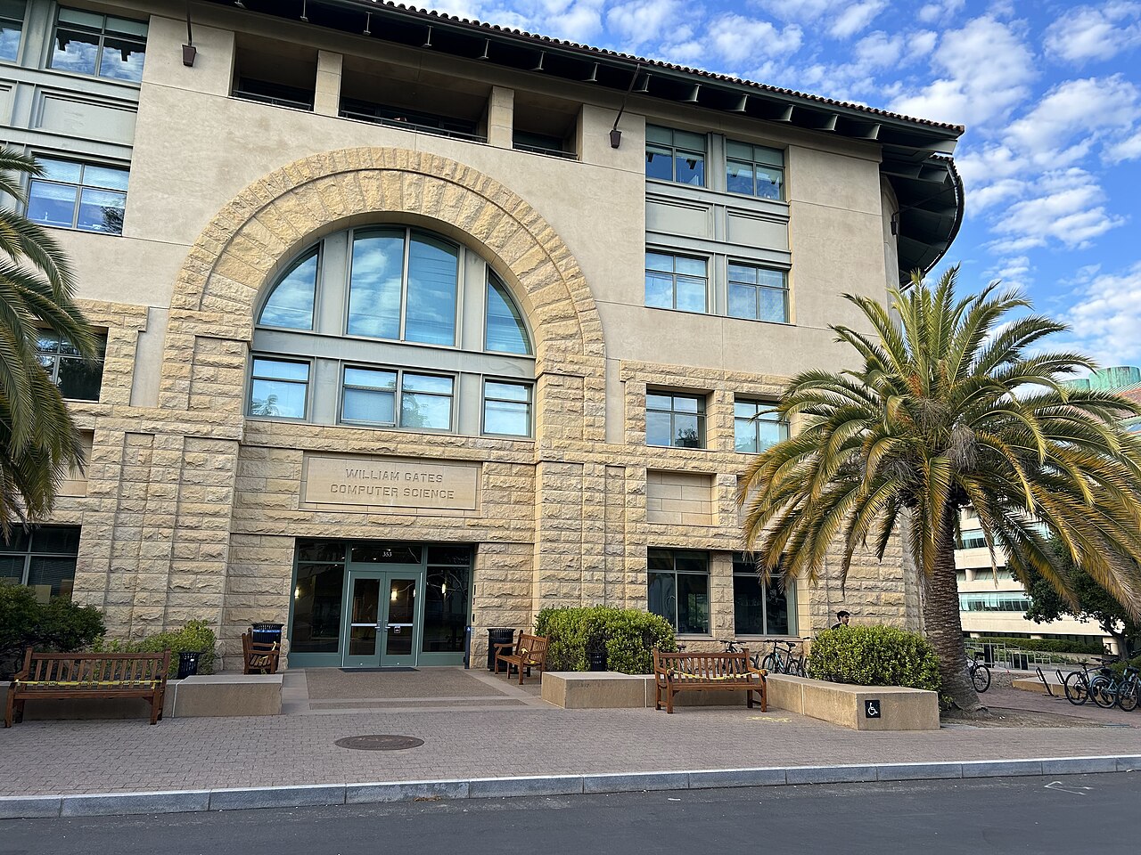 Stone campus building with computer science lettering and palms.