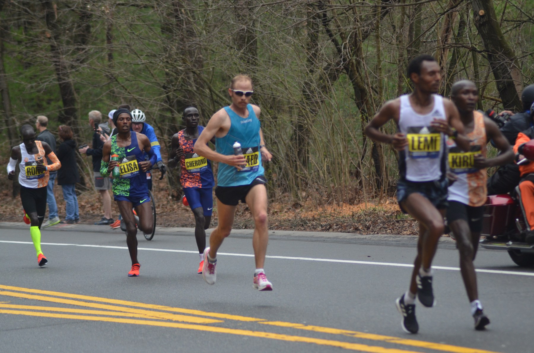 A pack of runners on the Boston Marathon course in 2019.
