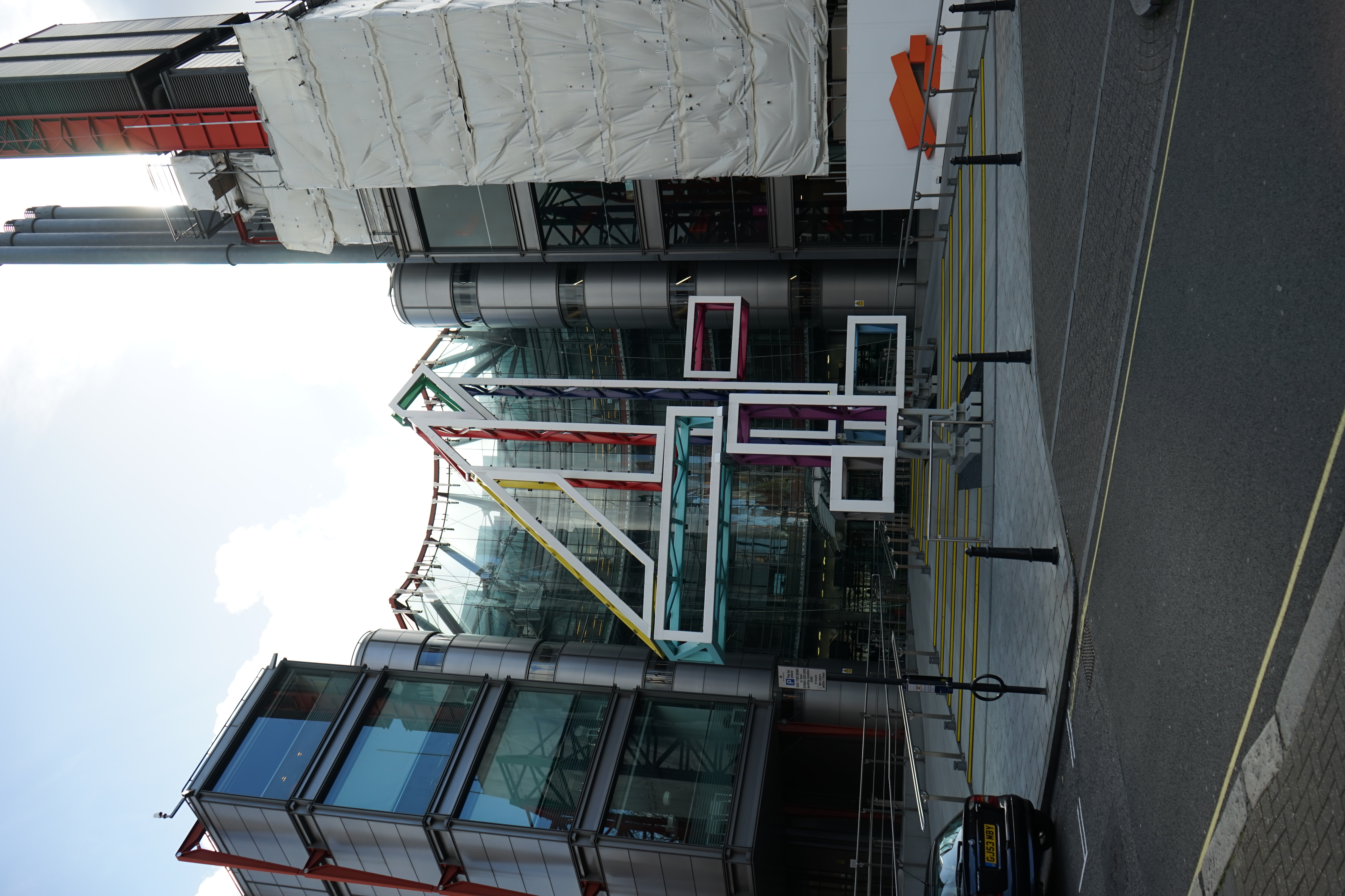 Glass-fronted Channel 4 building with a large outline numeral 4 outside