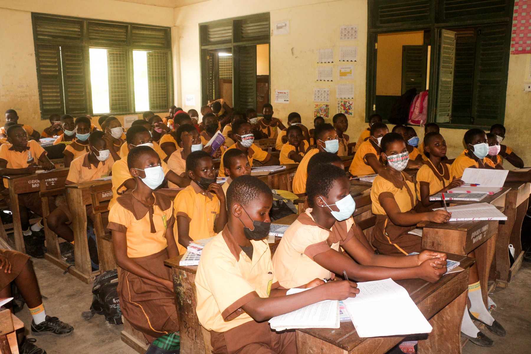 Students seated at desks in a Ghanaian classroom.