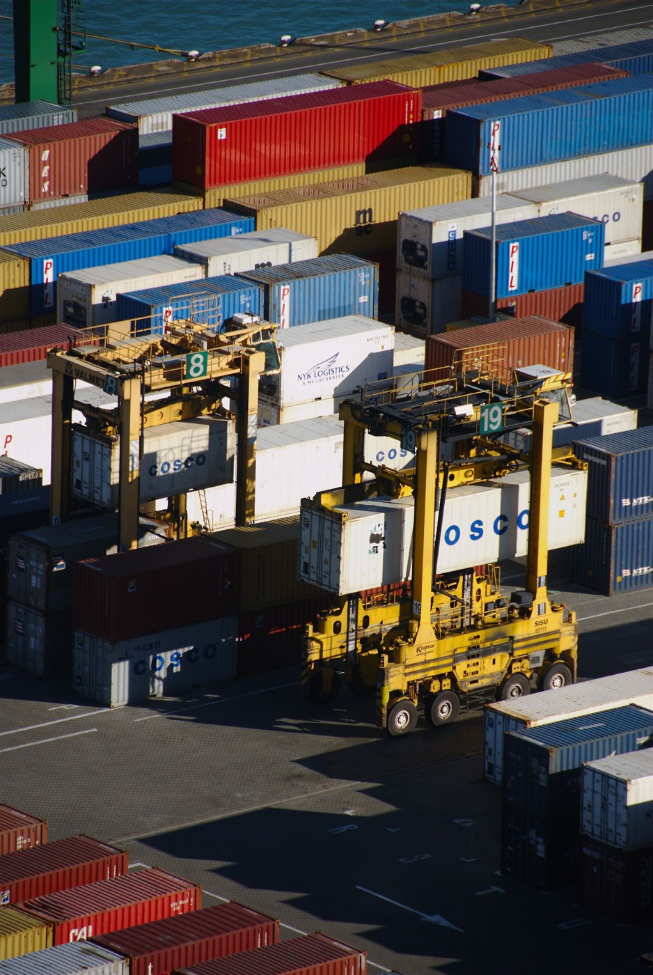 Stacks of freight containers and container-handling equipment.