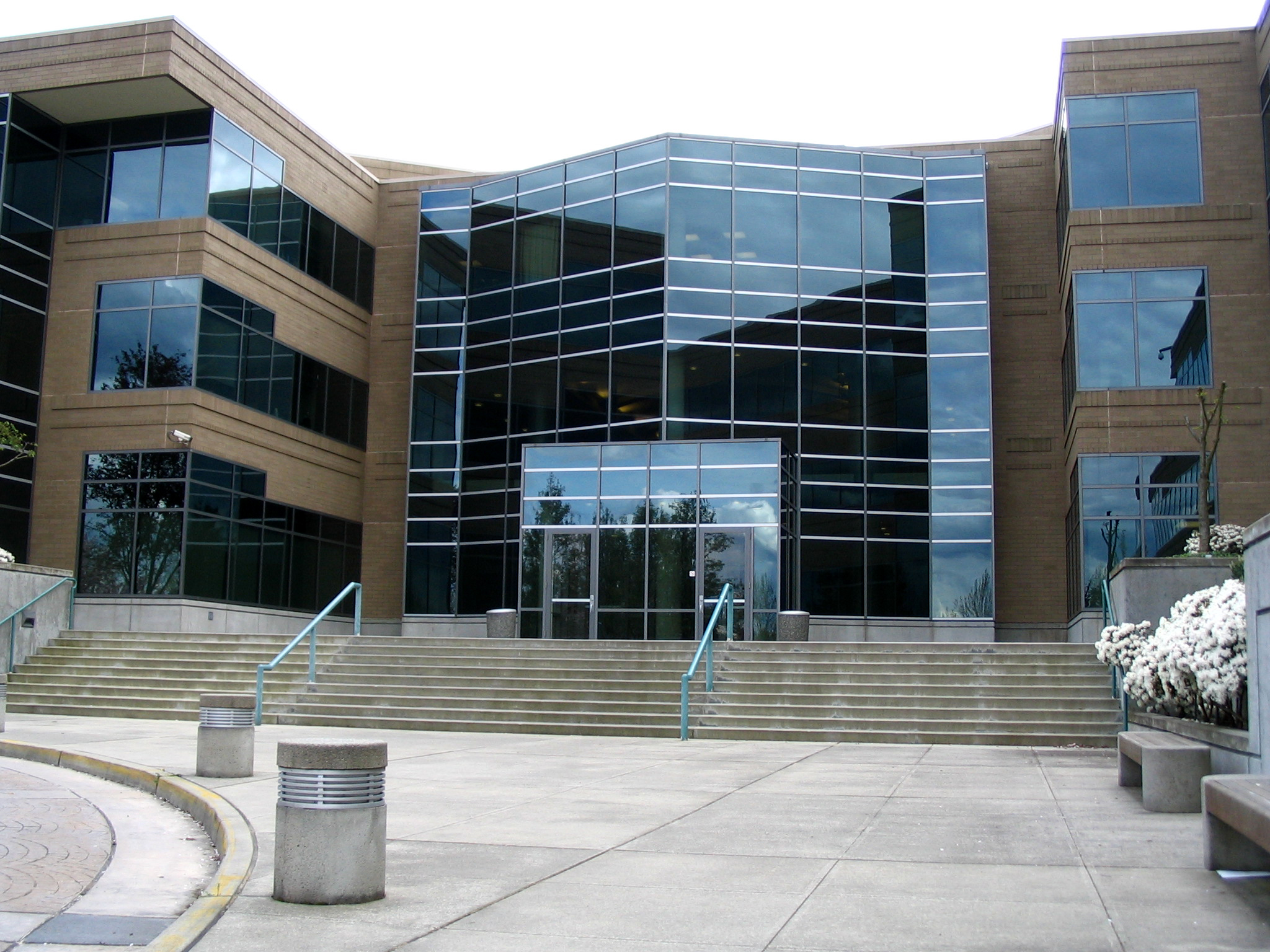 Glass entrance, stairs and landscaped grounds outside Microsoft Building 17 in Redmond.