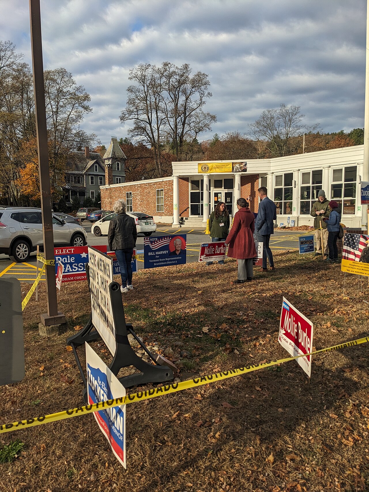 People and campaign signs outside the American Legion polling location in Brattleboro, Vermont.