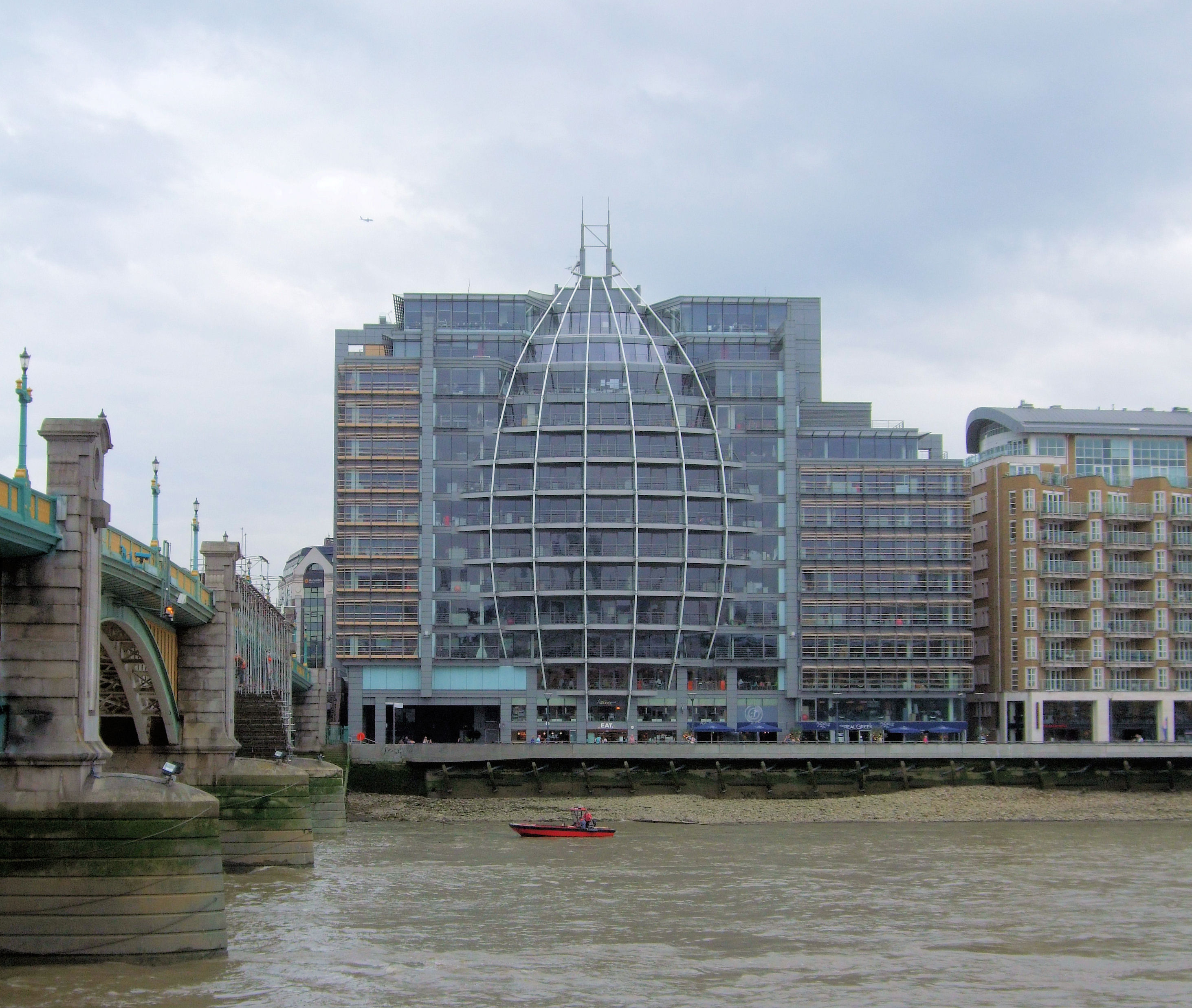 Riverside House beside the River Thames and Southwark Bridge.