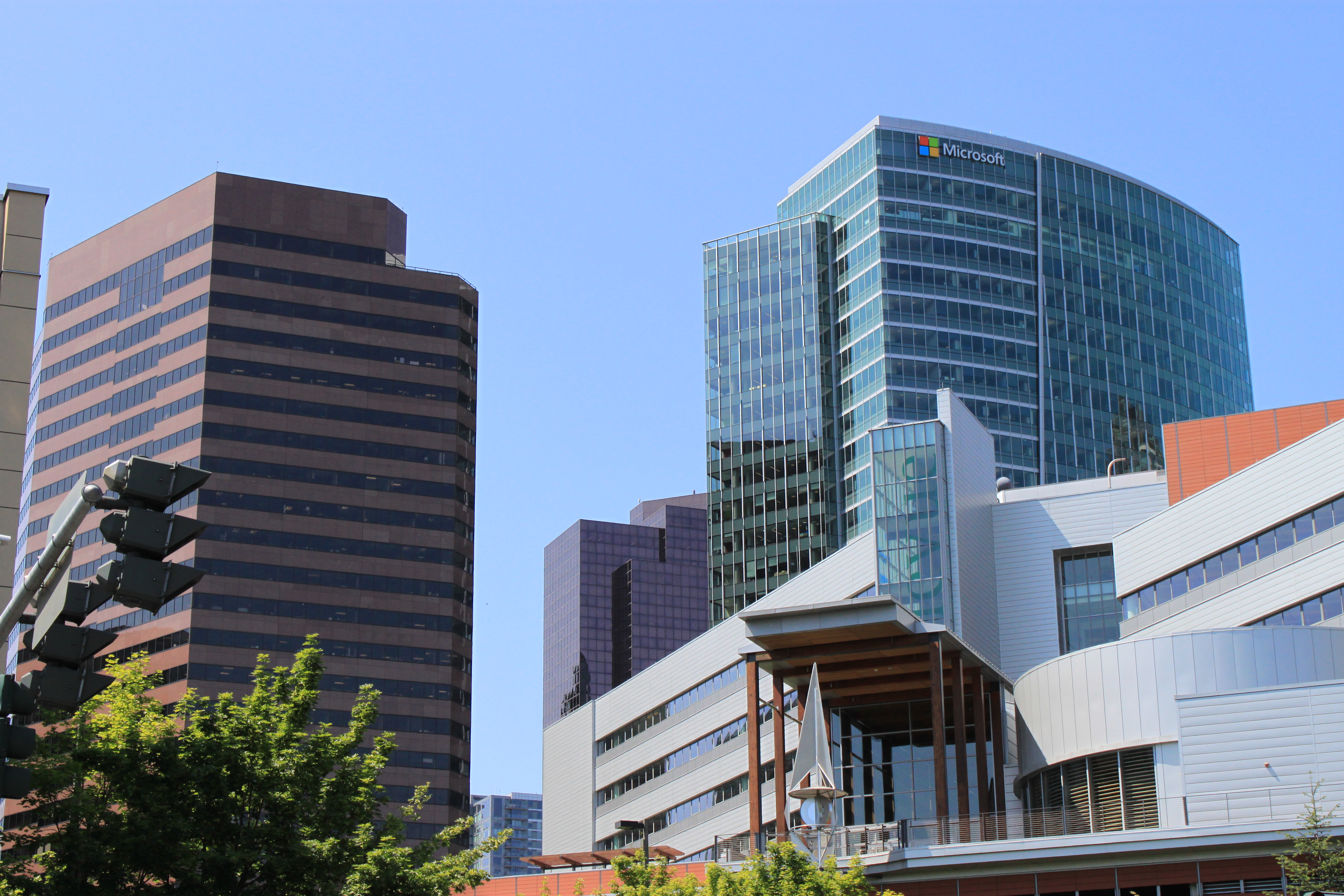 Brown Skyline Tower at left beside a taller glass building carrying a Microsoft sign.