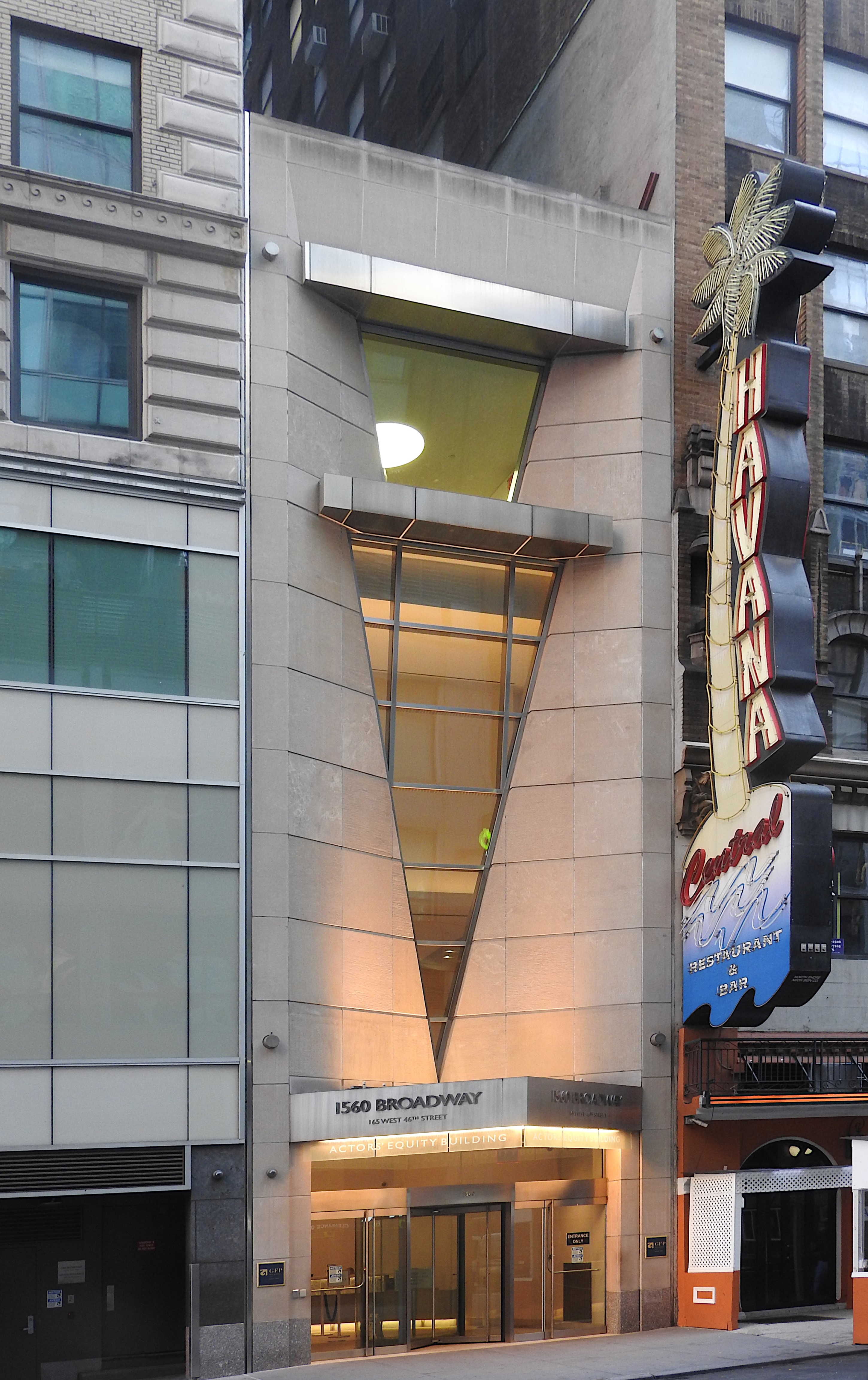 Actors’ Equity Building entrance beside a vertical restaurant sign.
