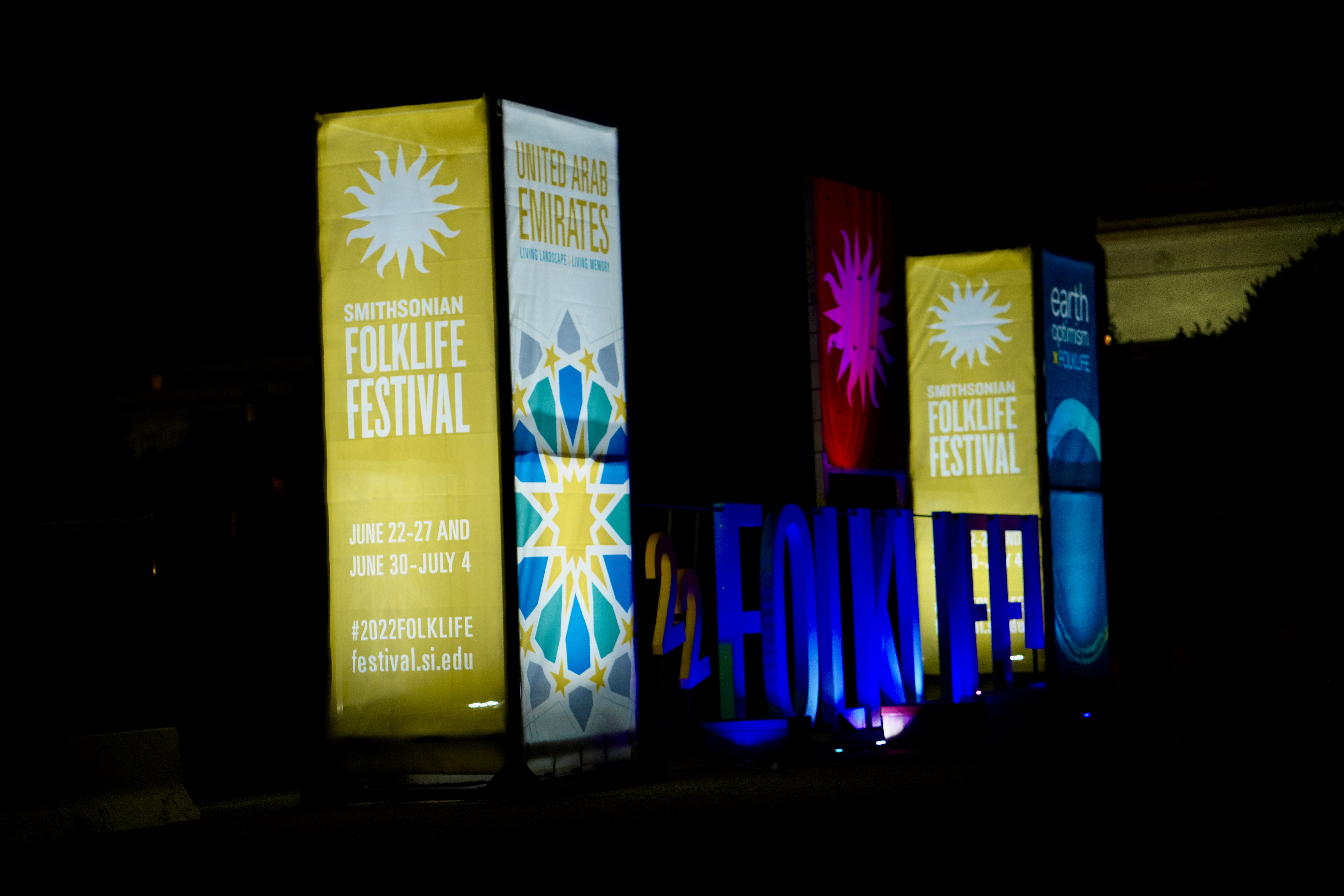 Illuminated Smithsonian Folklife Festival panels and large festival letters after dark.