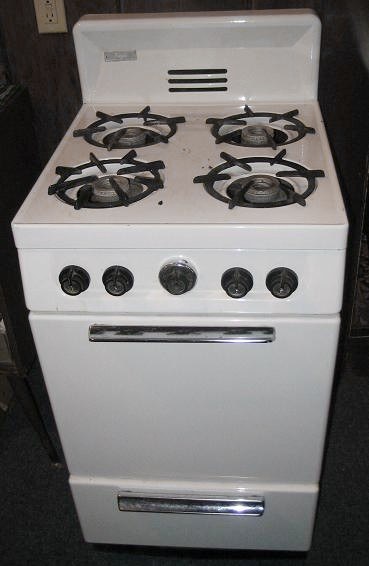 A white gas range with four burners and an oven.