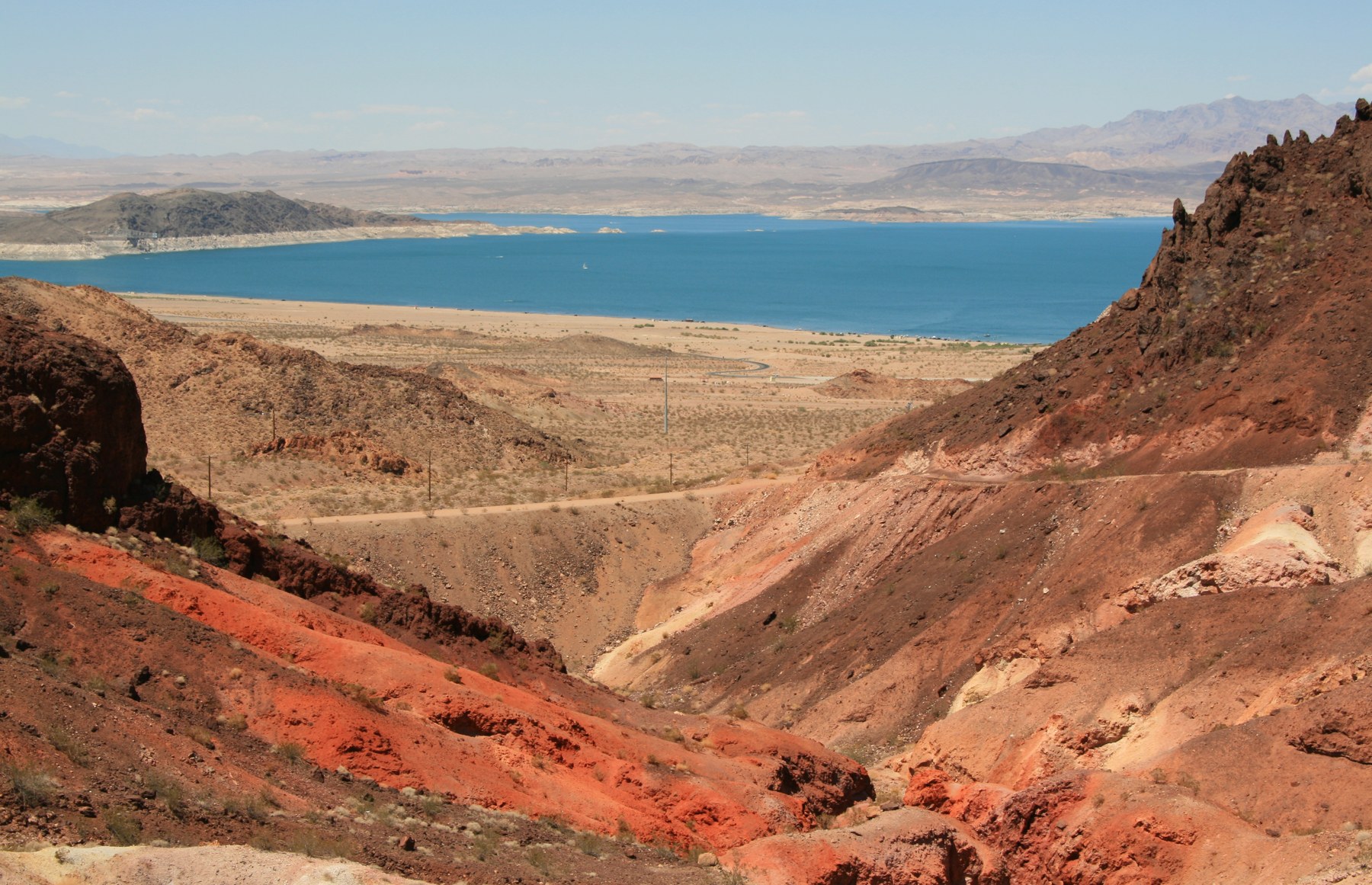 Lake Mead’s blue water beyond a rocky desert slope.