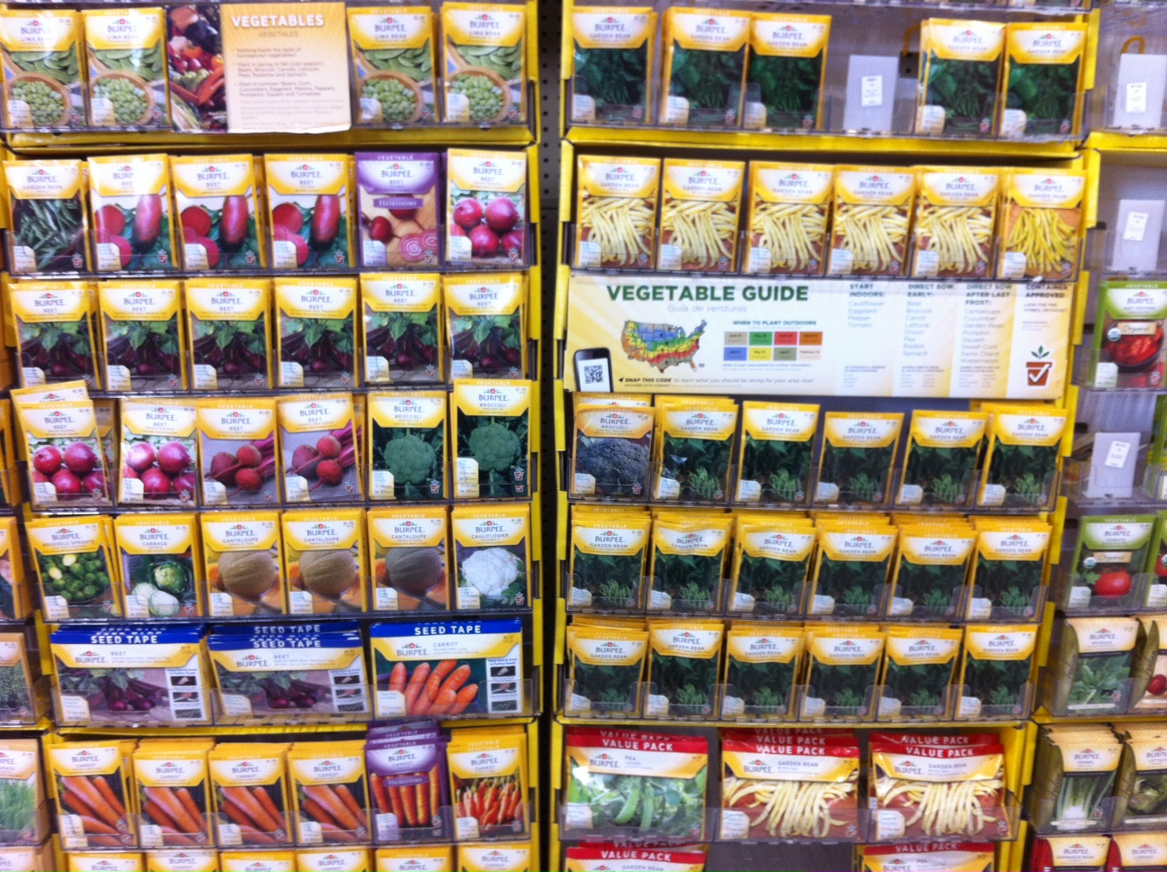 Vegetable seed packets displayed on a retail rack.