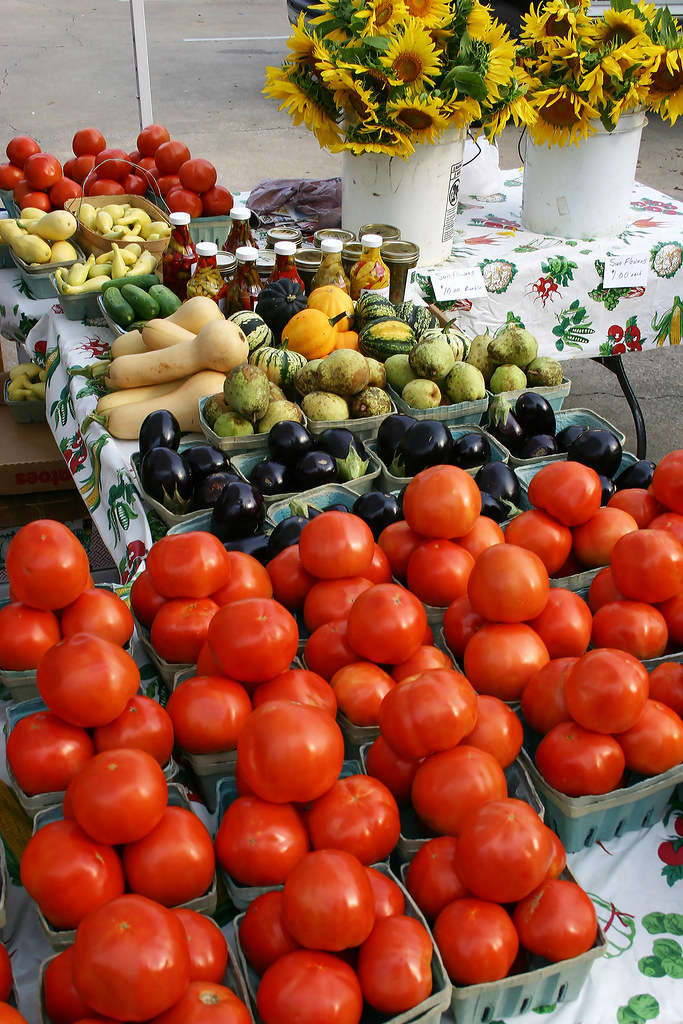 Tomatoes, squash and other produce on a market table.