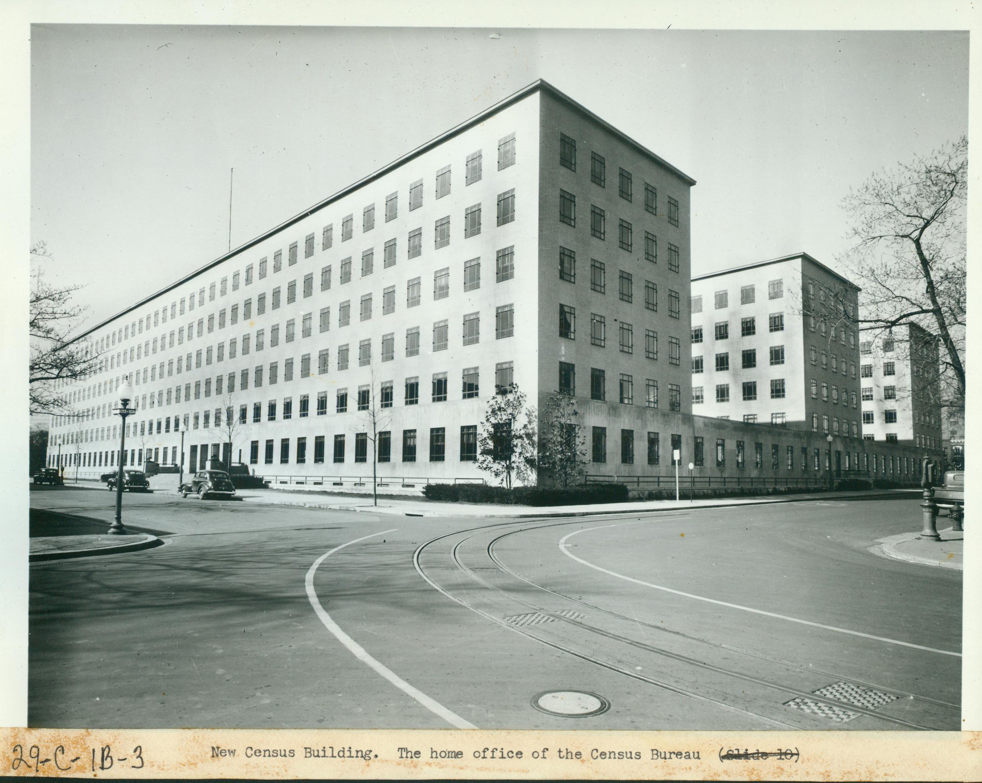 An archival Census Bureau building with period cars.