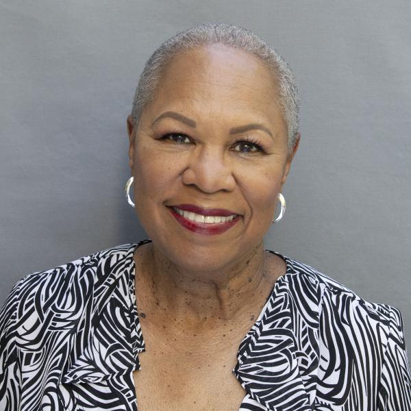 Rhonda Hamilton smiles in an official portrait against a gray background.