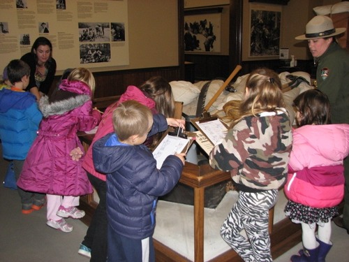 File photo: children look at a museum exhibit with a park ranger.