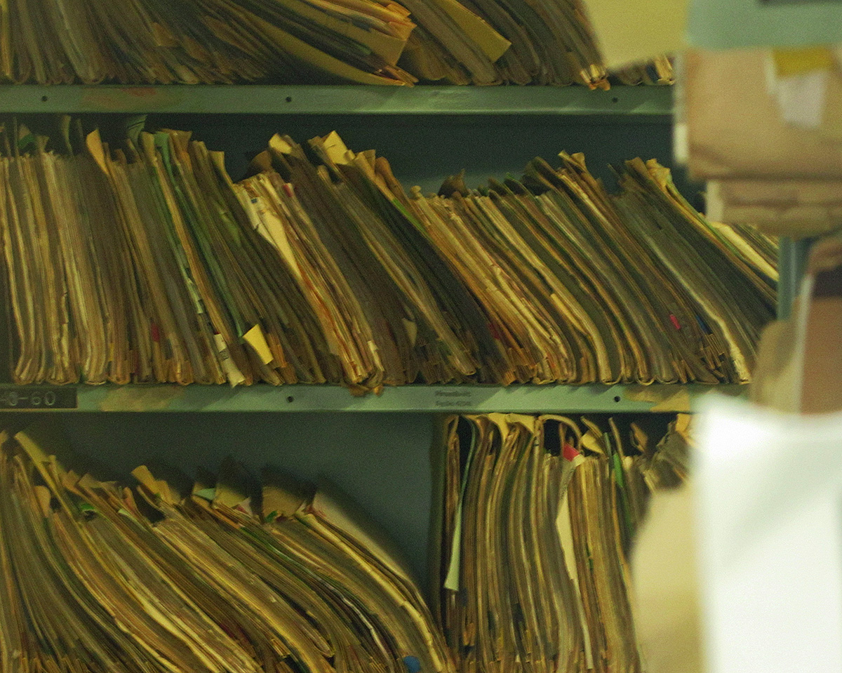Shelves packed with paper files.