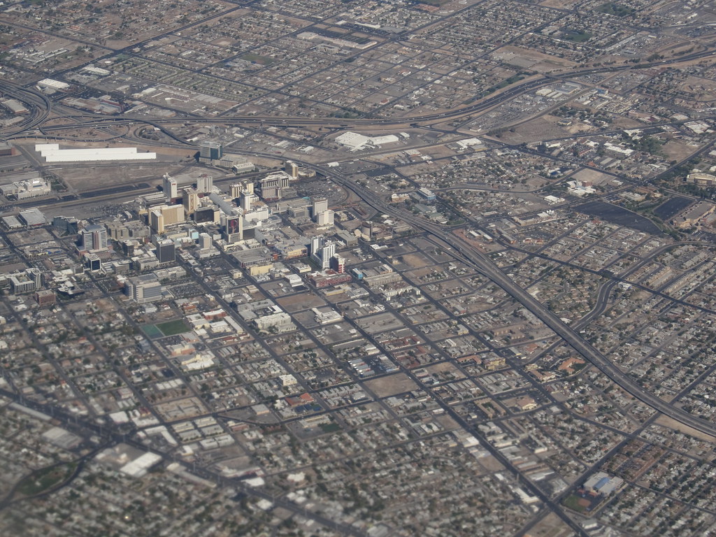 File photo (2012): aerial view of downtown Las Vegas buildings, street grid and freeways.