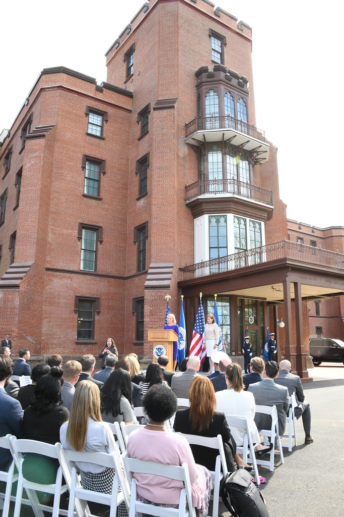 Brick headquarters building above an outdoor opening ceremony.