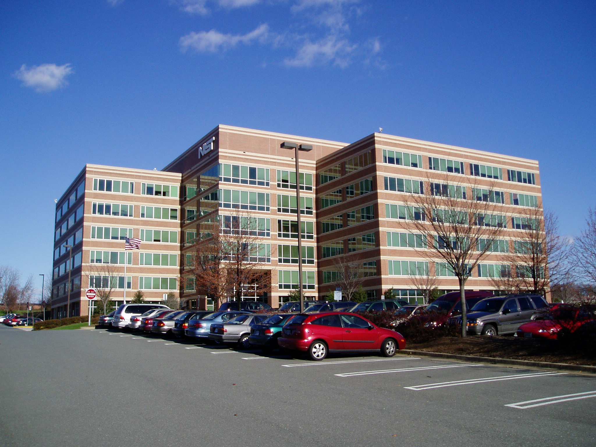 A NIST office building beside a parking area.