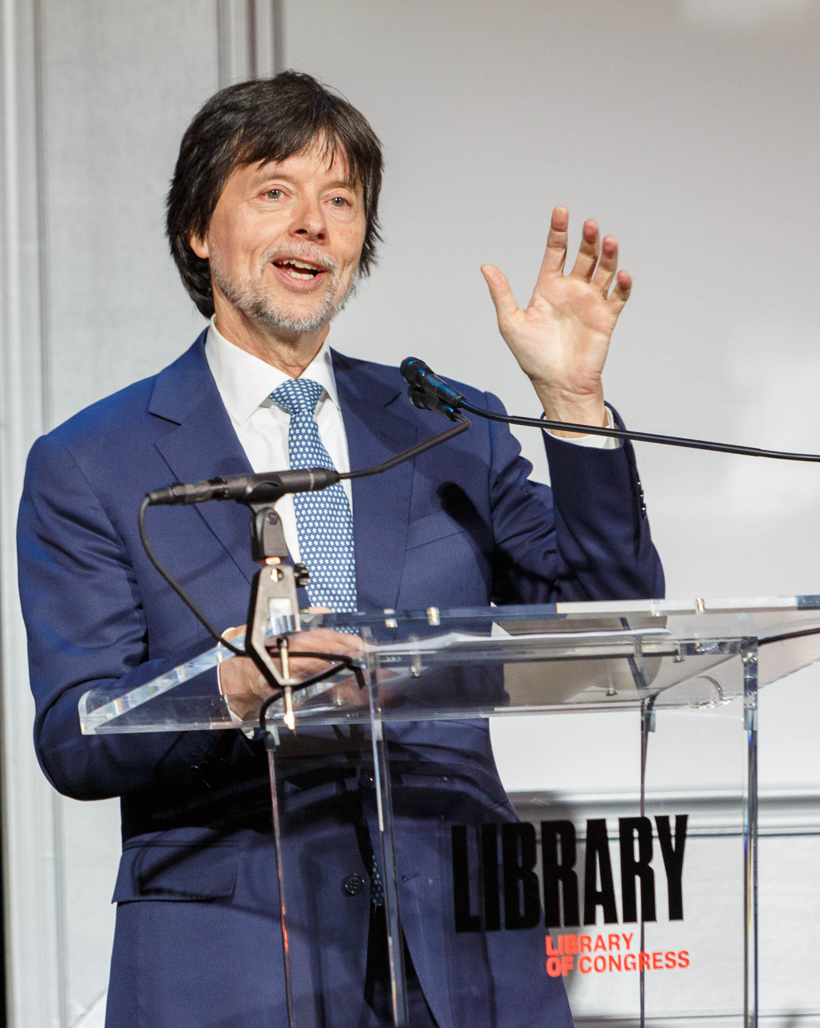 Ken Burns speaking at a lectern