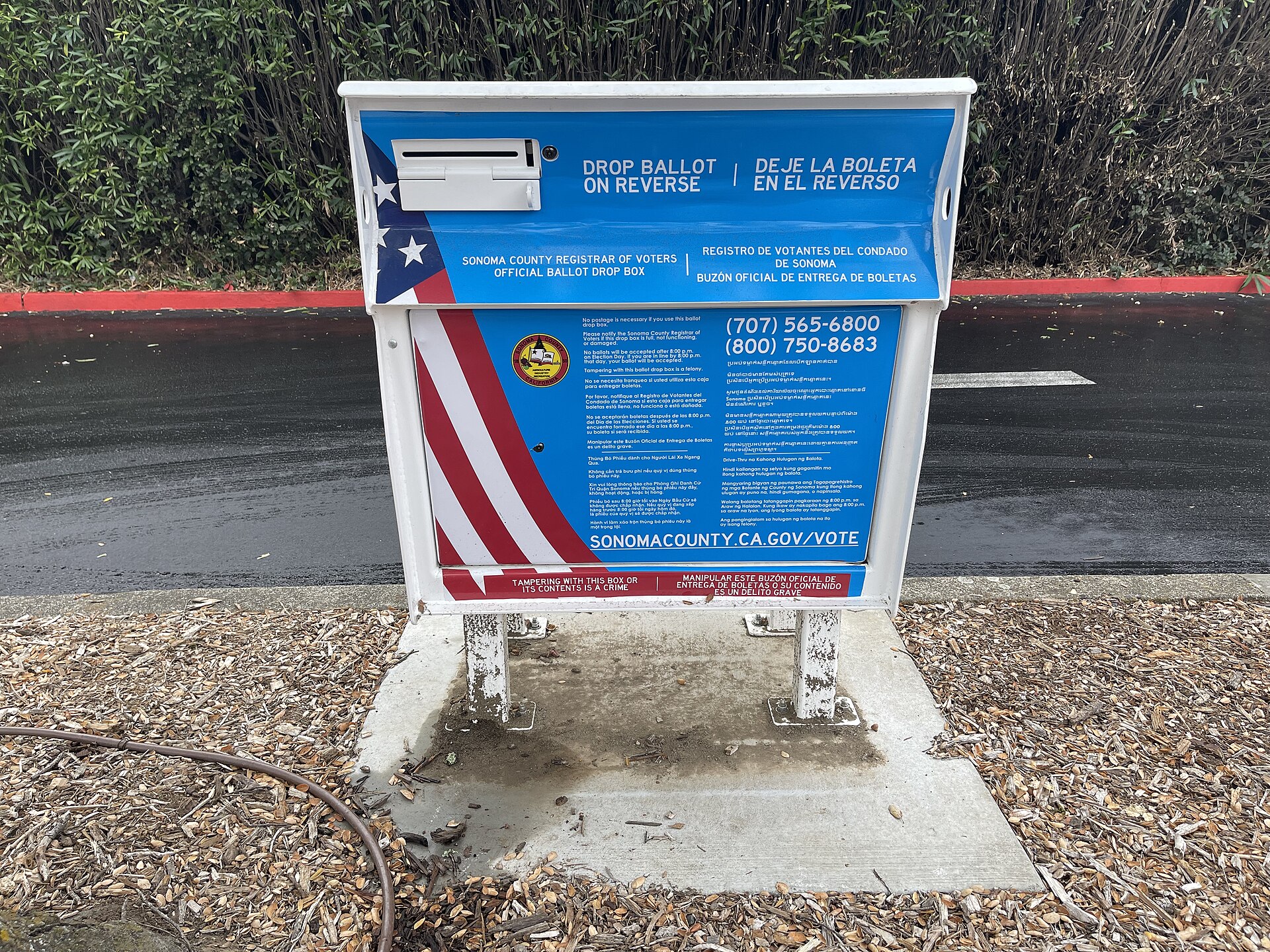 A blue-and-white Sonoma County ballot drop box with voting instructions.