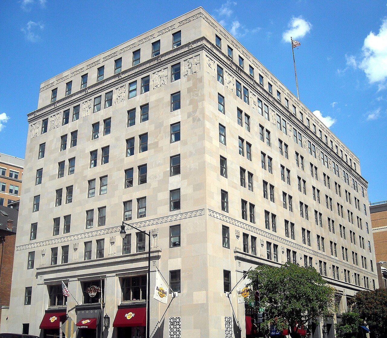 Stone office building with street-level restaurant awnings.
