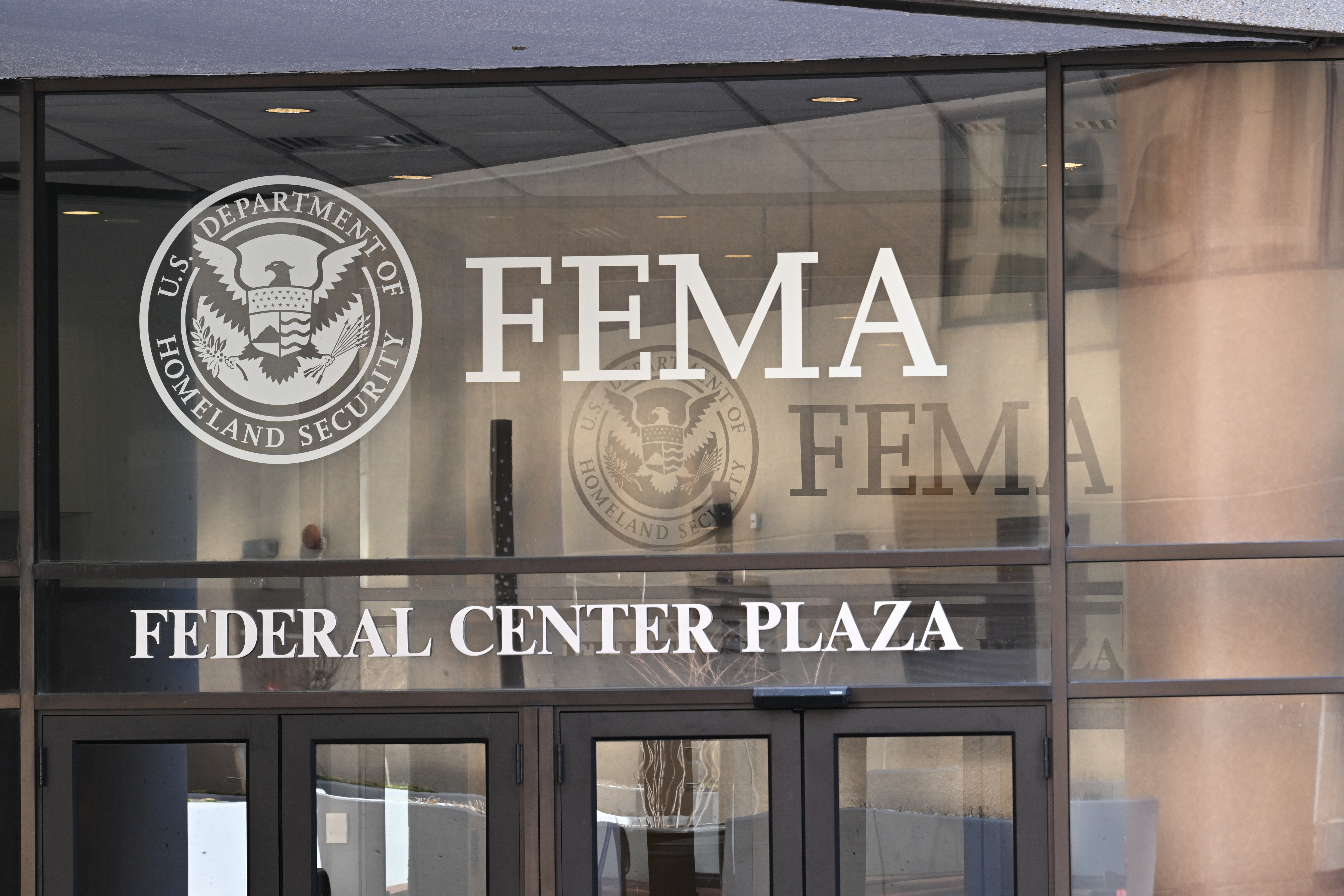 FEMA lettering and a Homeland Security seal on a glass entrance.