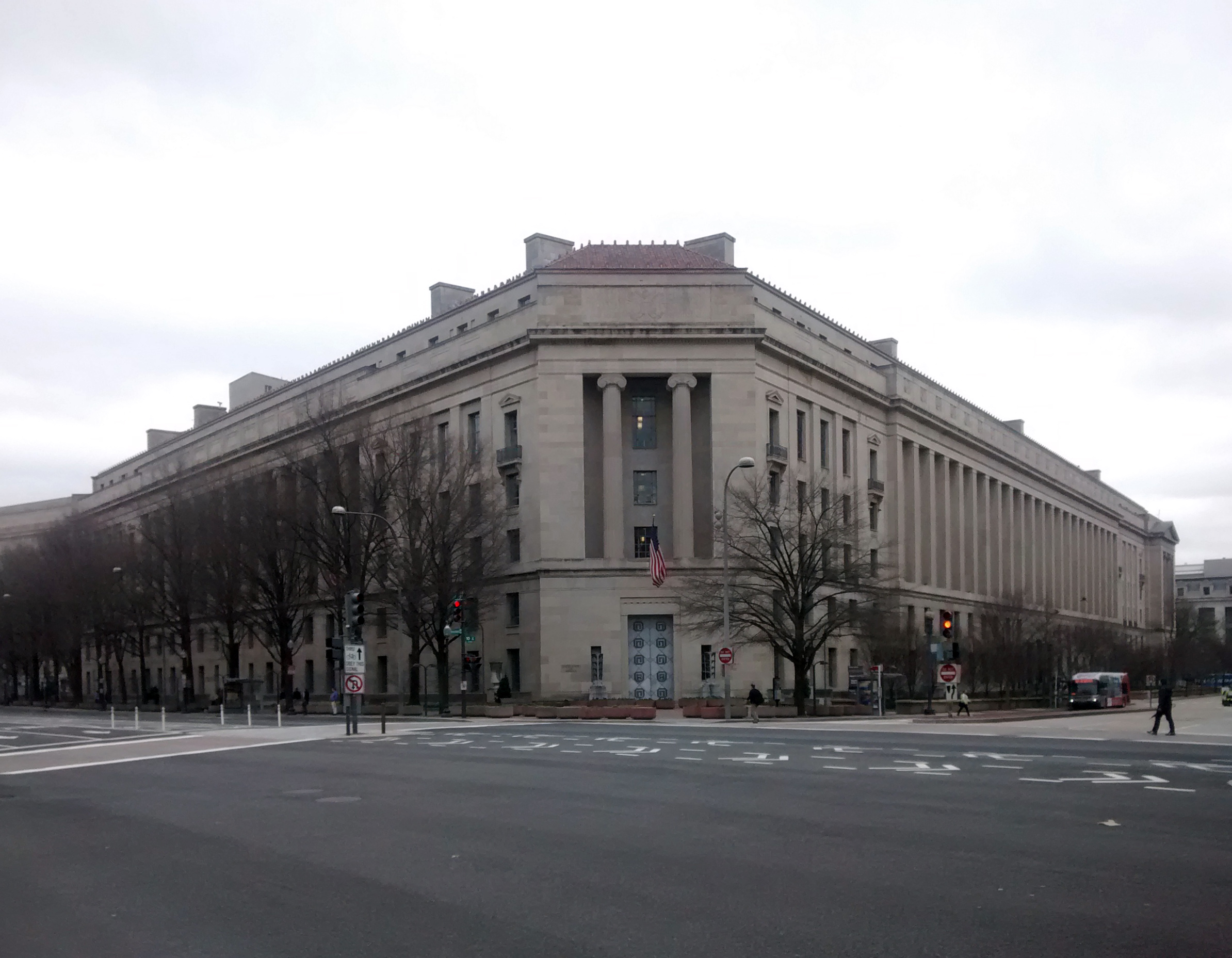 Justice Department’s stone building at a street corner.