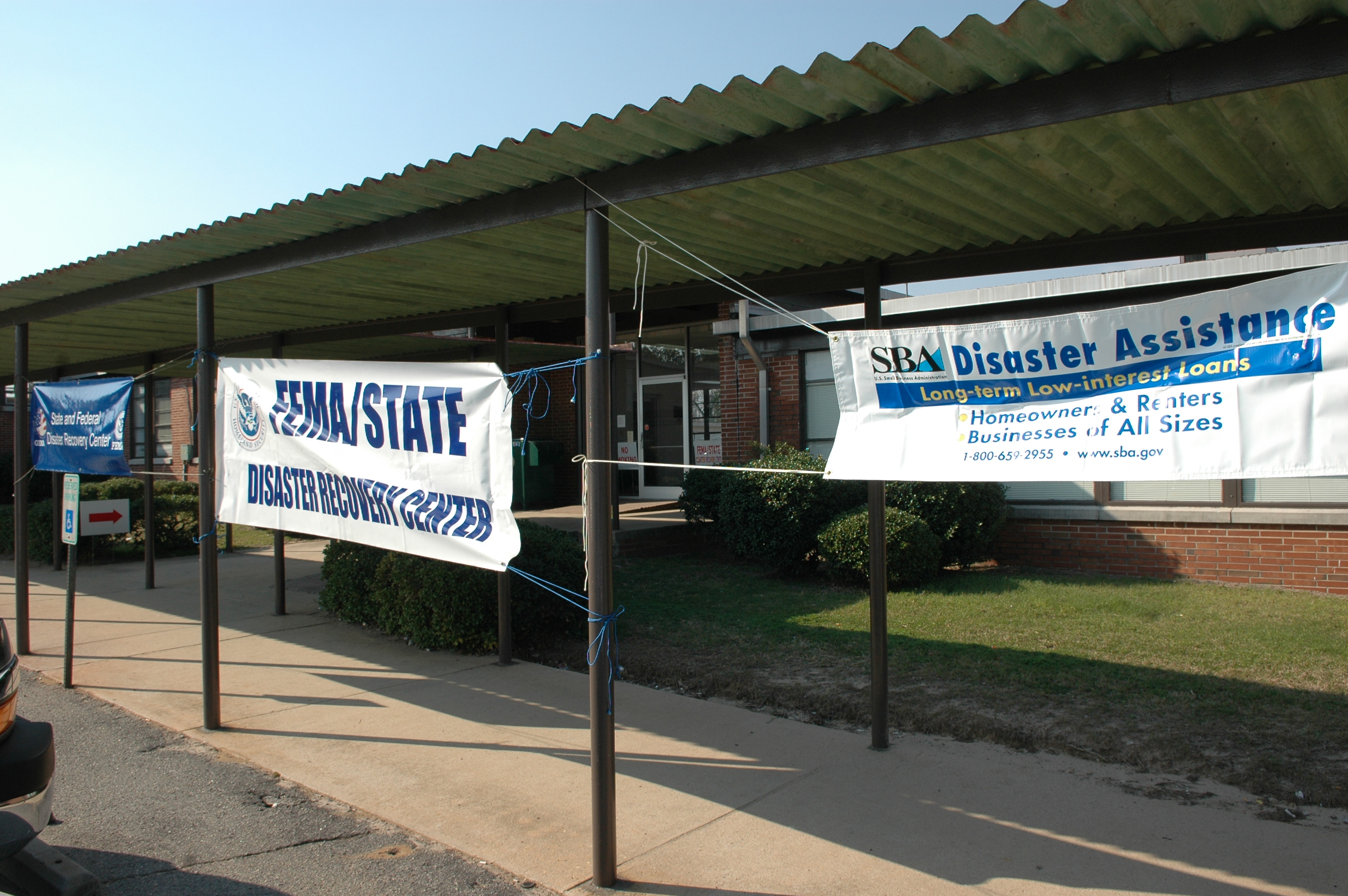 FEMA and SBA banners outside a brick disaster recovery center.