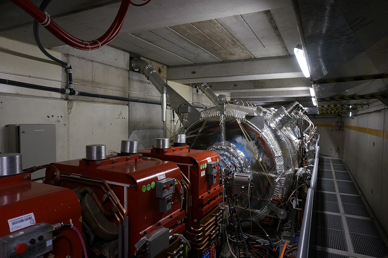 Red magnets, metal equipment and a walkway inside CERN.