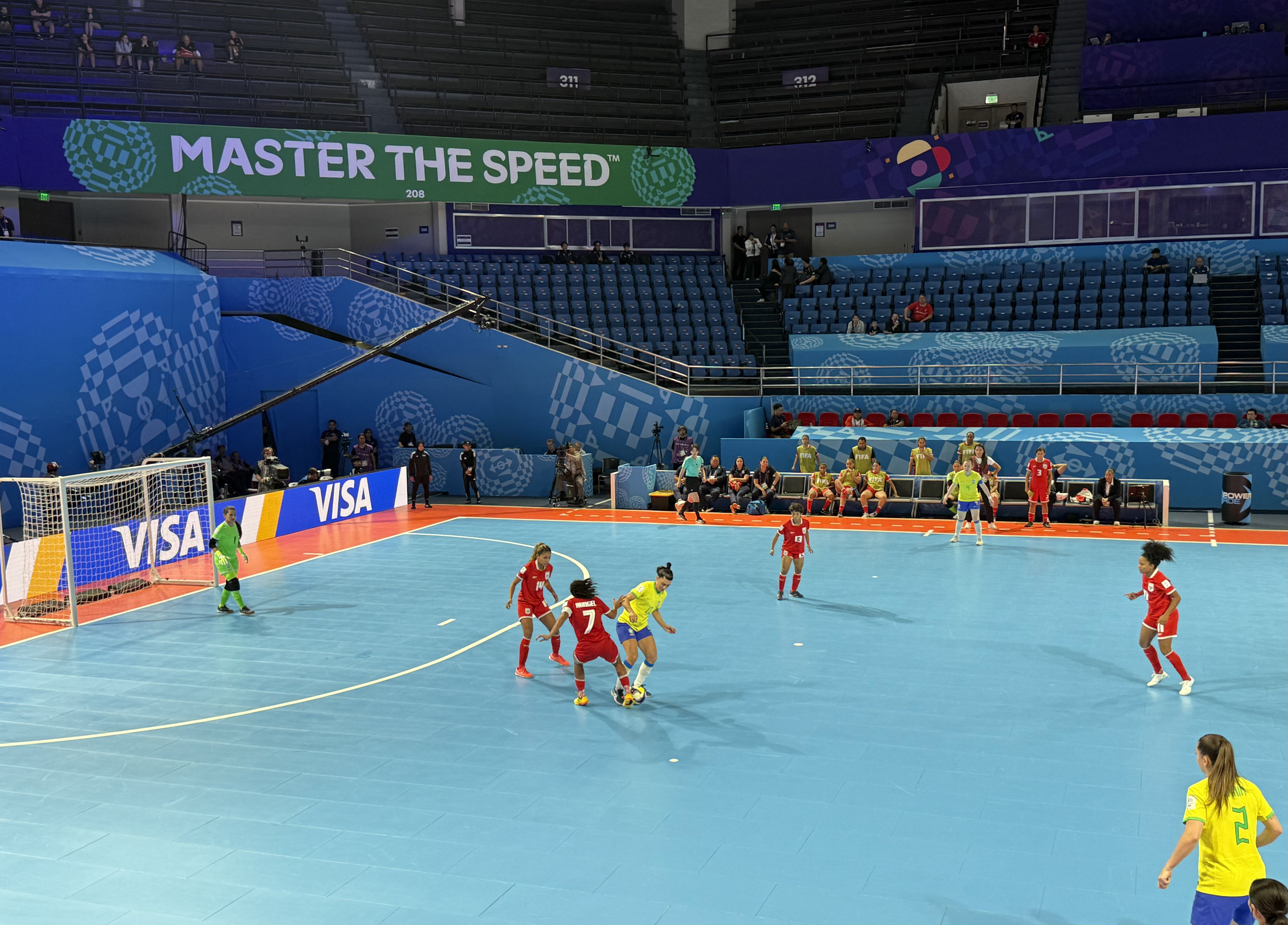 Brazil in yellow and Panama in red on an indoor futsal court.