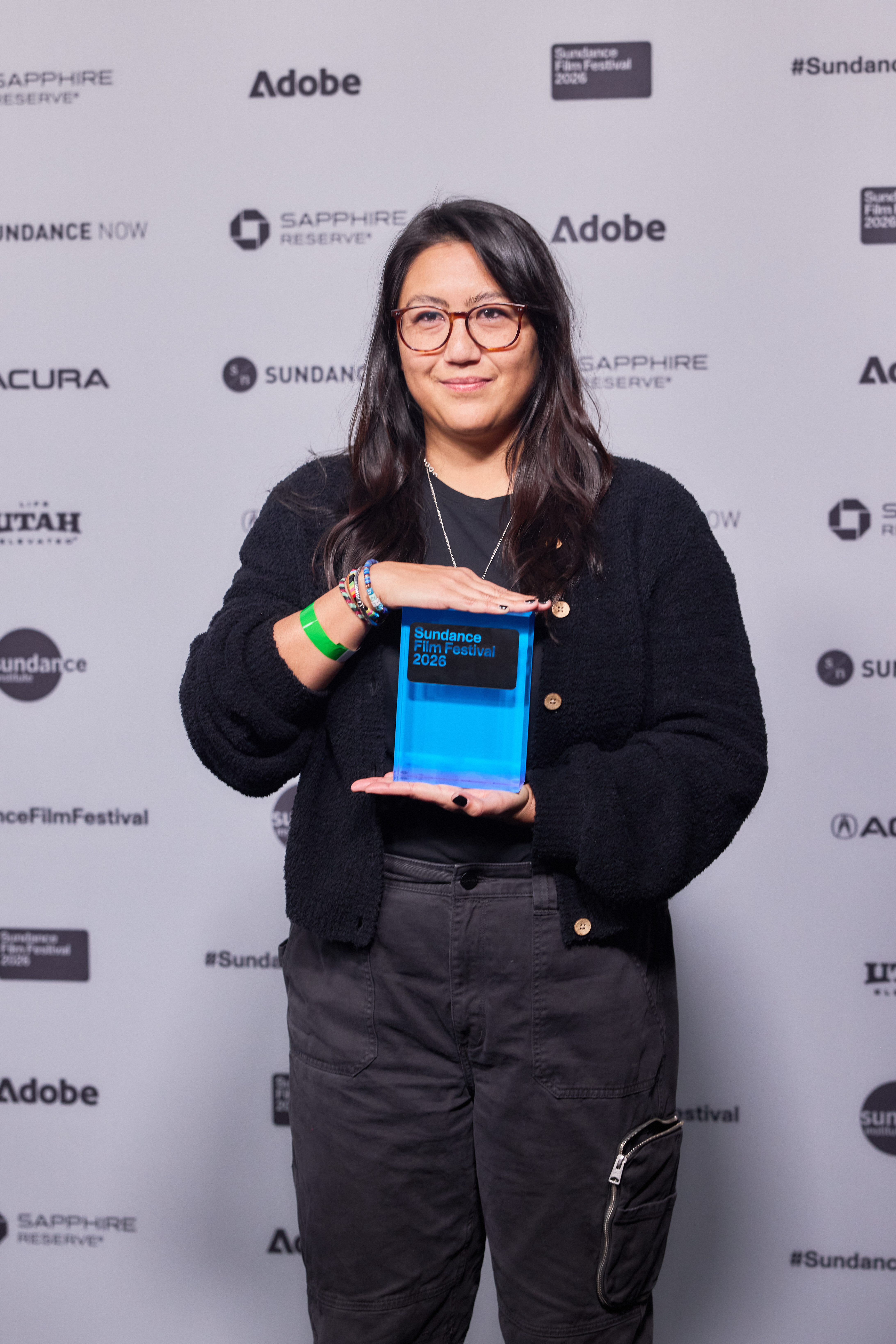 Beth de Araújo holding a blue Sundance award