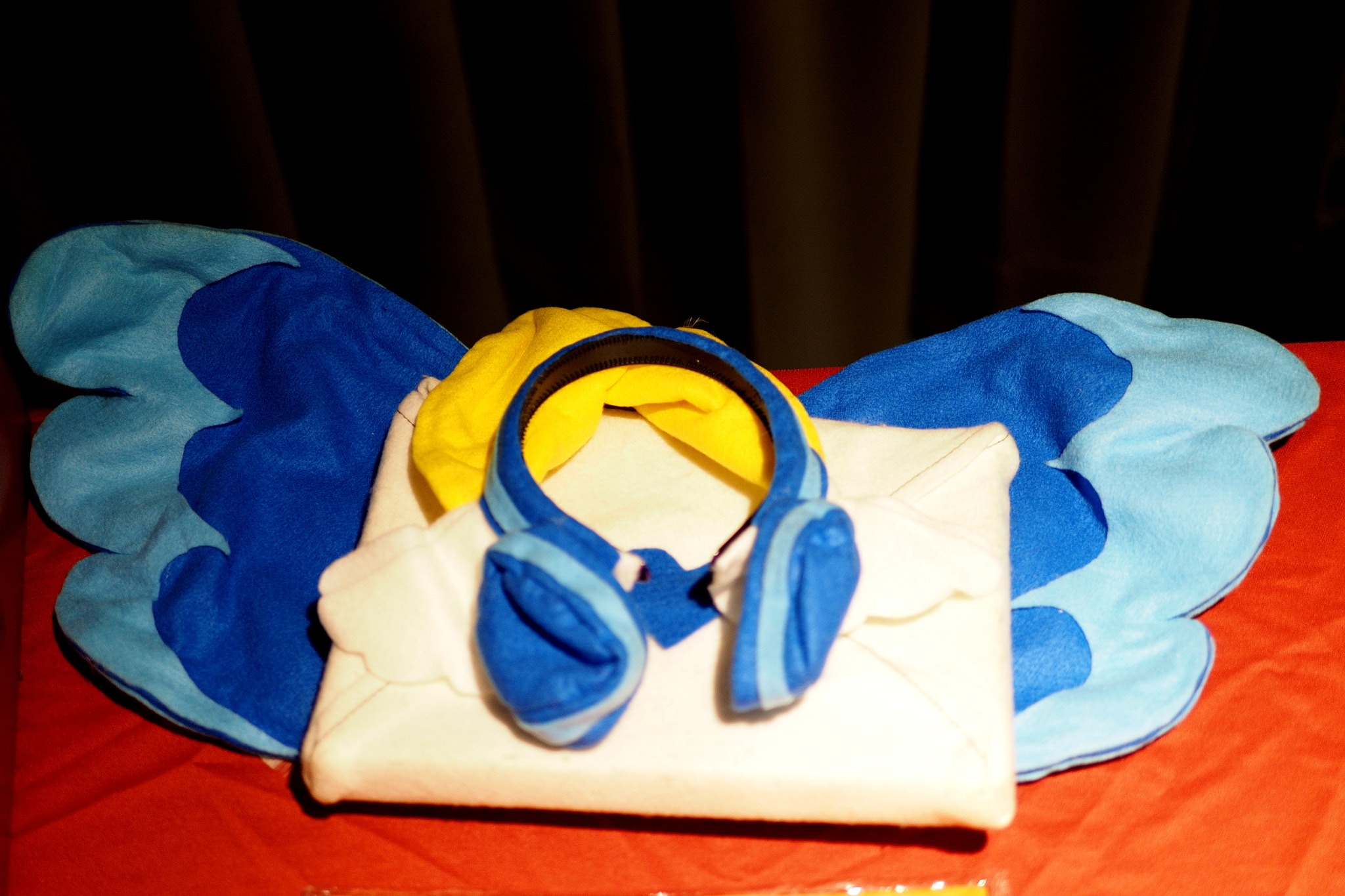 Blue bird wings and a mascot head rest on red seats.