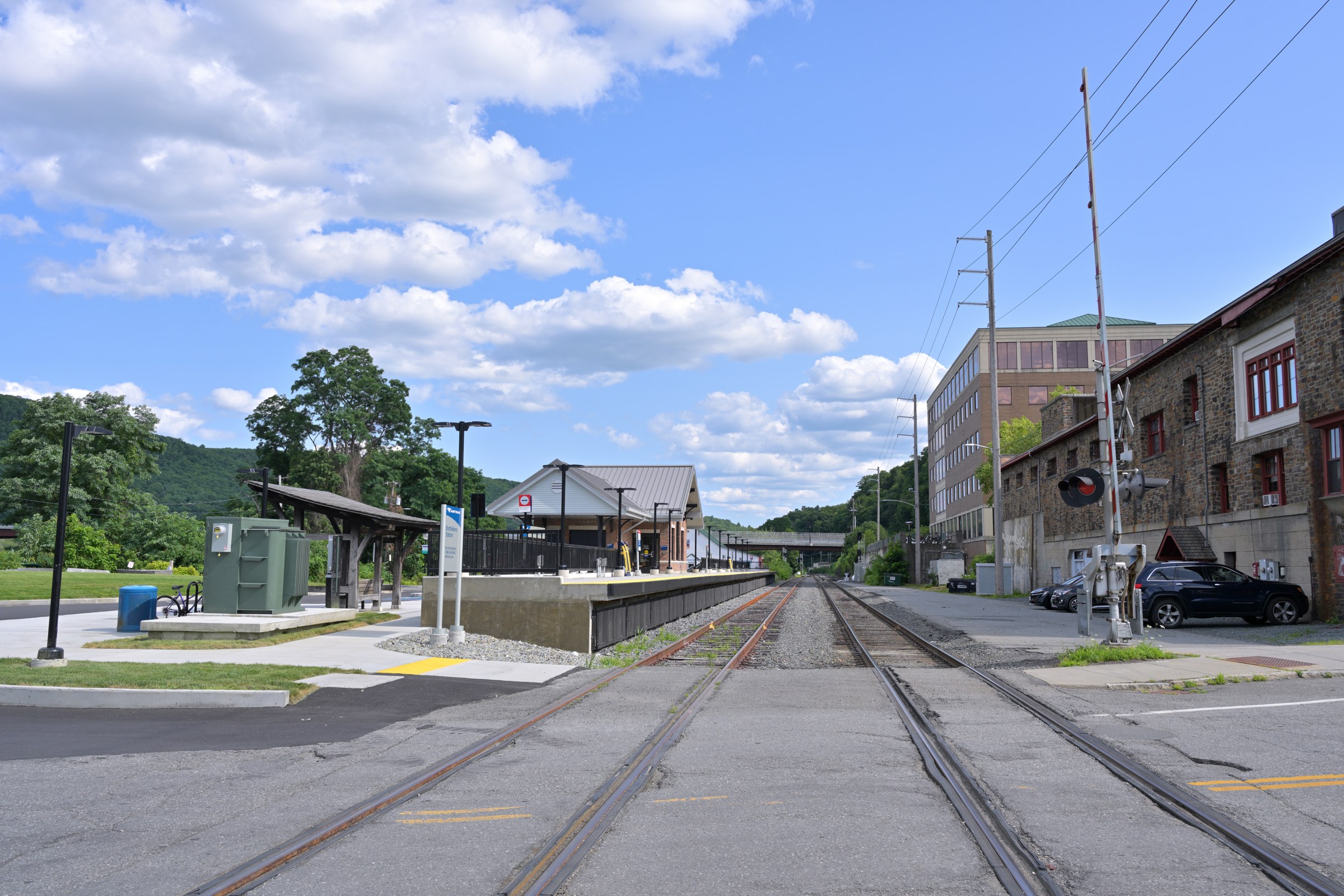 The new Brattleboro station and raised platform beside railway tracks.