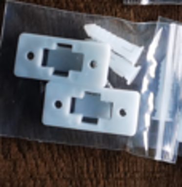 Bagged white plastic brackets.