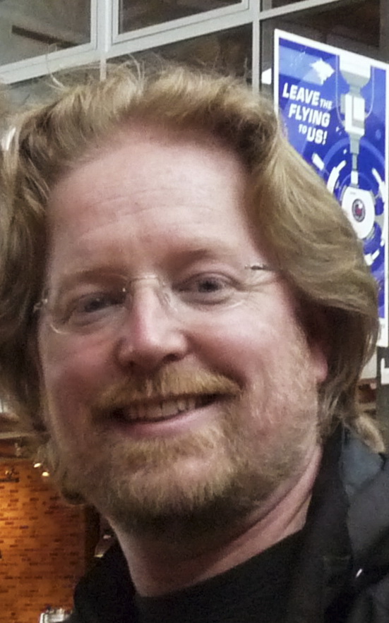 Andrew Stanton in a black shirt in an archival portrait