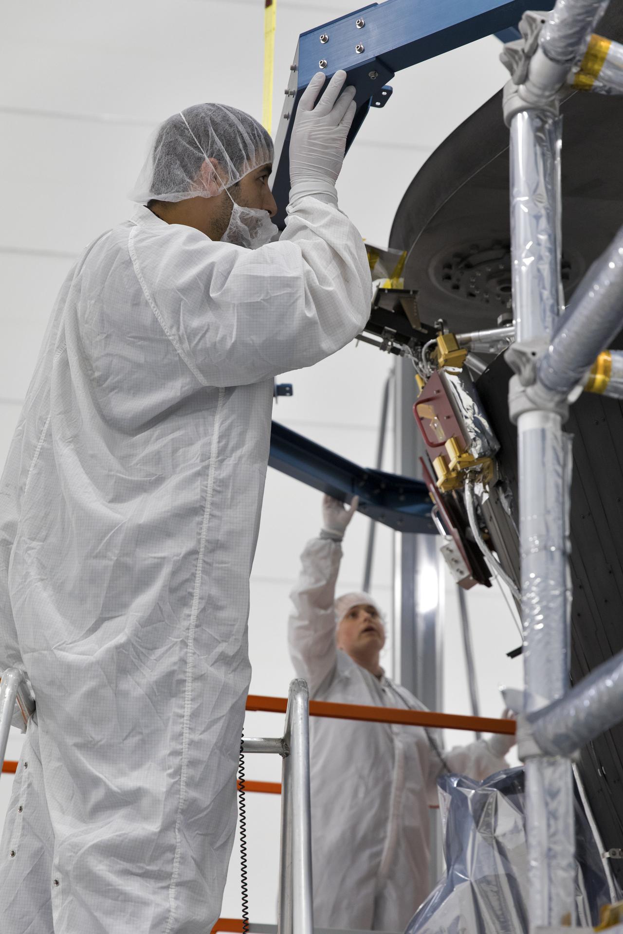 Technicians working on the Parker Solar Probe in a clean room.